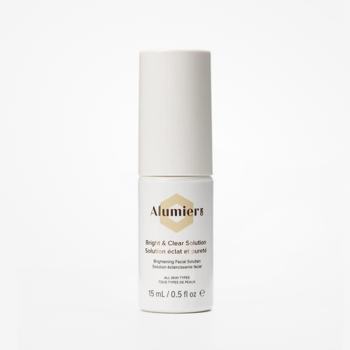 Travel-size Alumier Bright & Clear Solution Deluxe Mini by wedoskin, 15mL bottle with clear liquid for skin brightening.