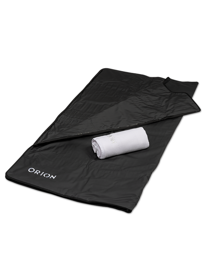 Orion Embers Sauna Blanket in black with a white towel, showcasing its soft, insulated exterior for home sauna relaxation.