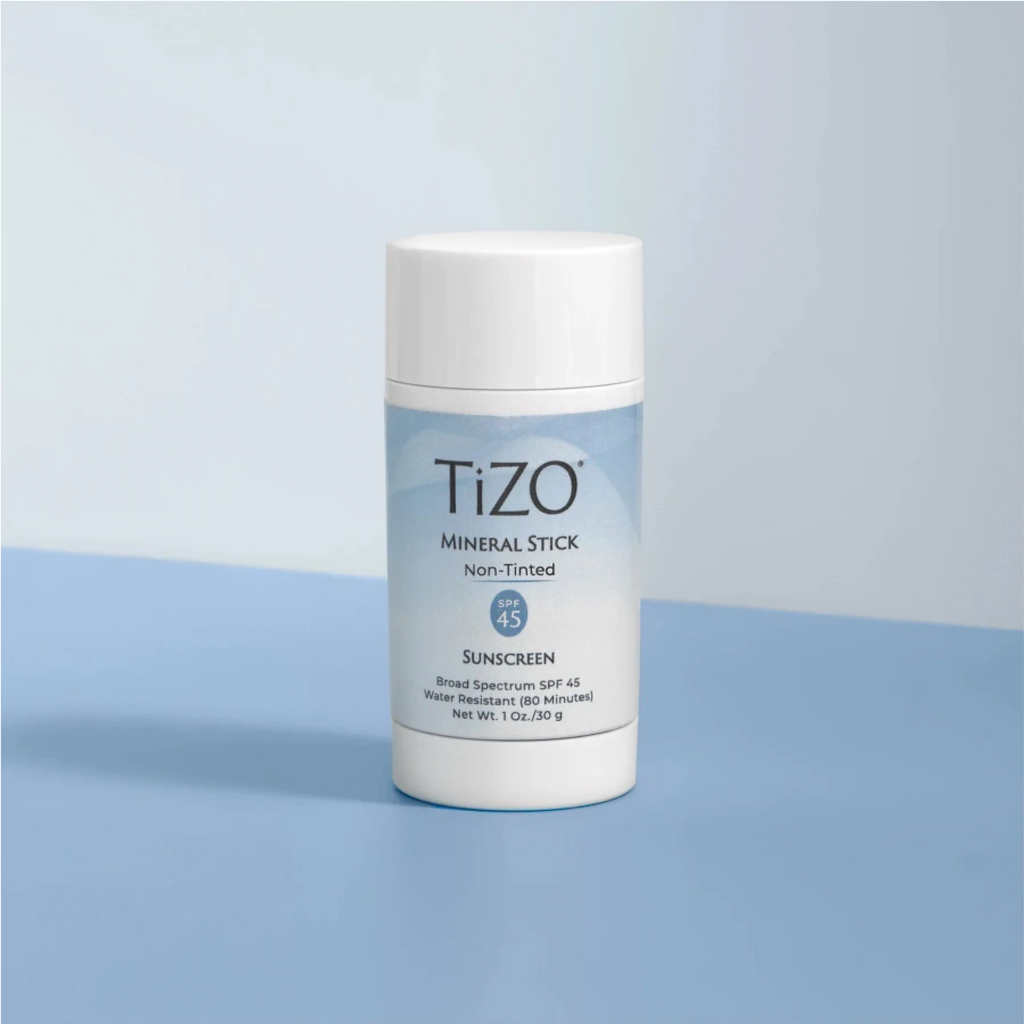 wedoskin TiZO® Mineral Stick SPF 45 tinted mineral sunscreen stick for face, showing the tinted formula in a compact container