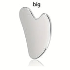 Stainless steel Gua Sha facial tool from MediSpa Aesthetica, showing smooth, curved design for facial massage and skincare.