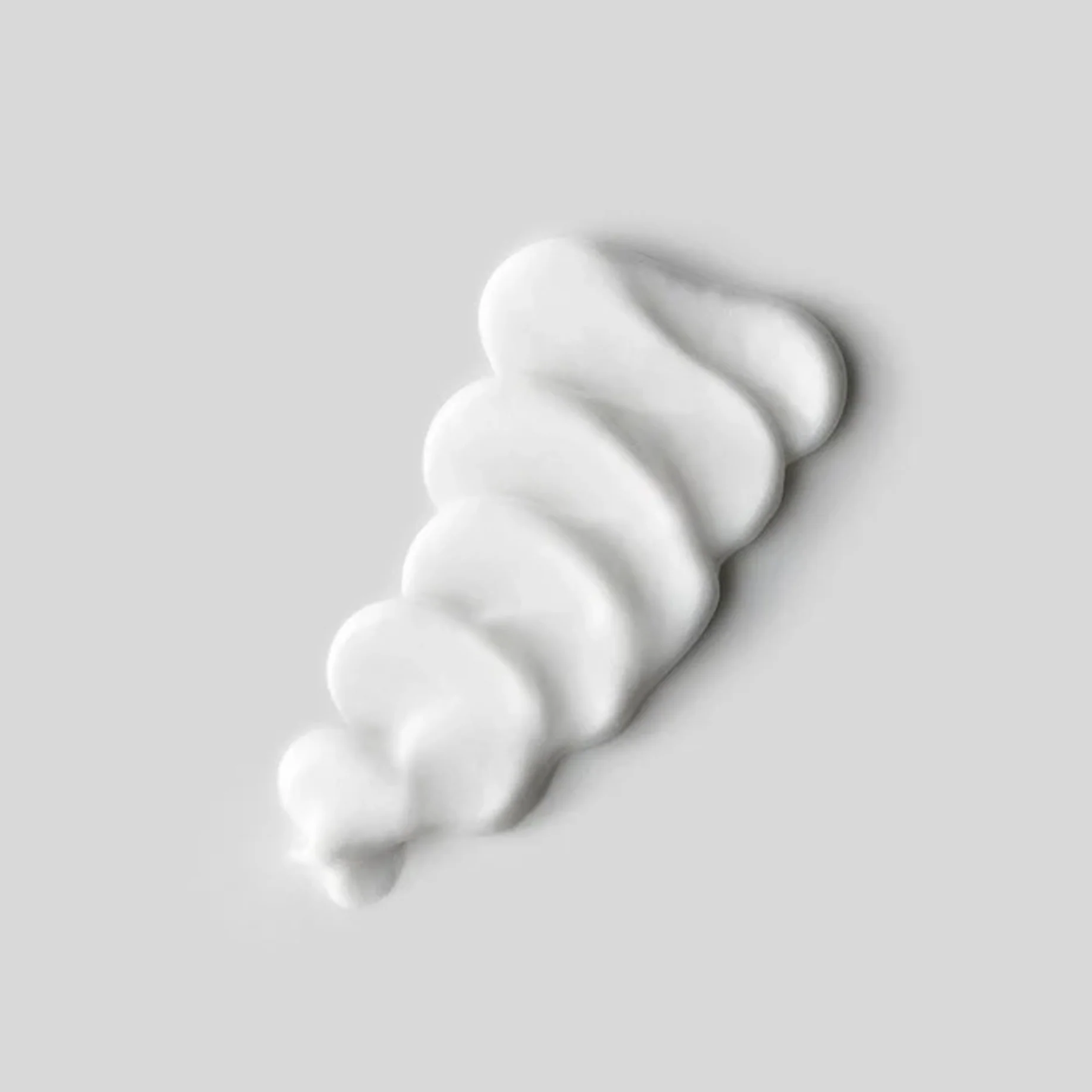 Cream texture of SACHAJUAN Finish Cream styling product by wedoskin, showing its smooth, thick consistency in a close-up image.