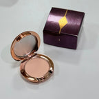 Charlotte Tilbury makeup products displayed in MediSpa Aesthetica Shop, featuring elegant packaging and a variety of beauty items.