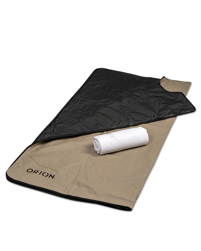 Orion Embers Sauna Blanket with a white towel, showcasing the heat-resistant exterior and comfortable interior for relaxing sauna sessions.