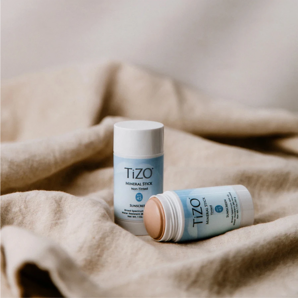 TiZO Mineral Stick SPF 45 tinted sunscreen by wedoskin, showing the compact stick with tinted mineral formula and packaging.