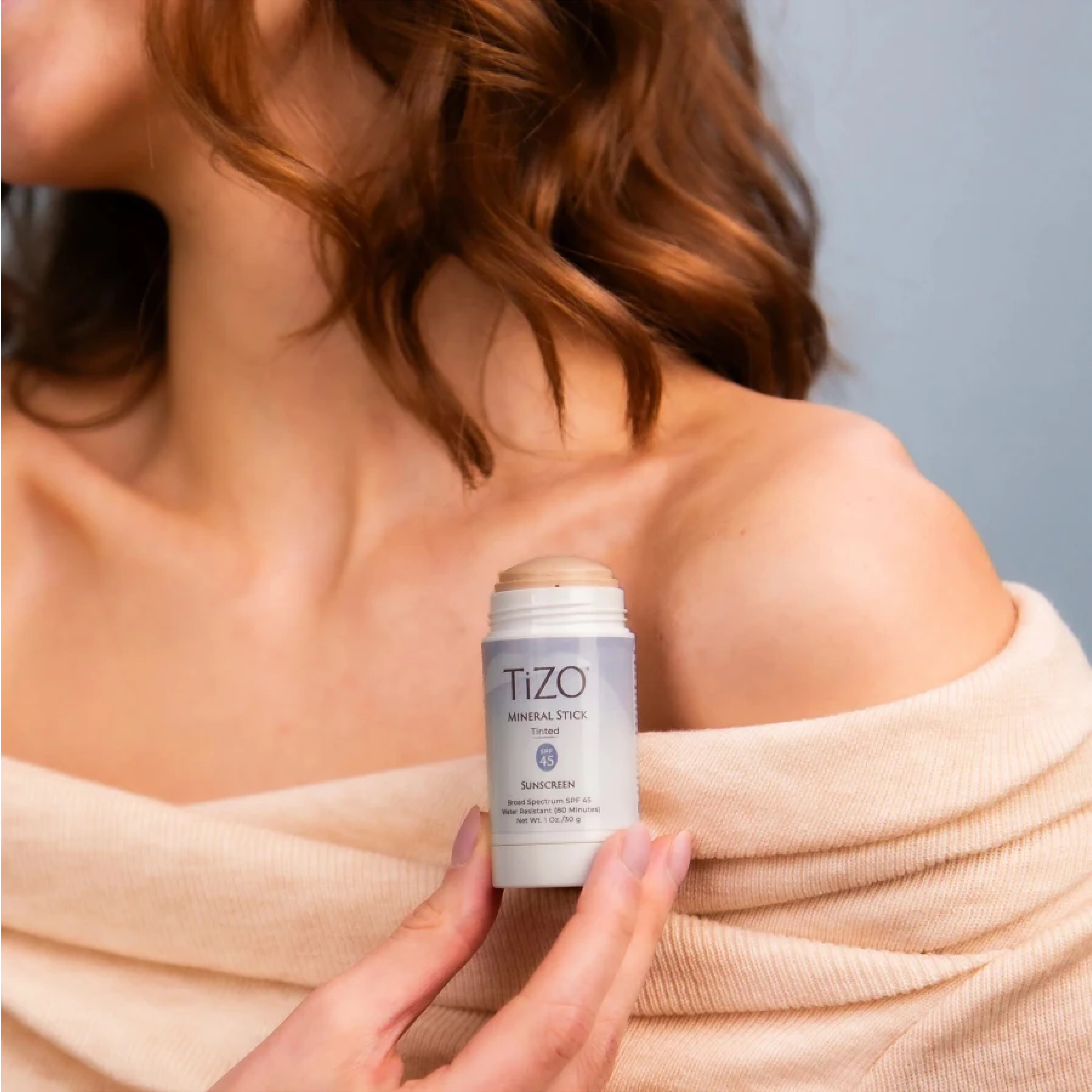 TiZO® Mineral Stick SPF 45 tinted sunscreen by wedoskin, showing the compact stick with tinted mineral sun protection.