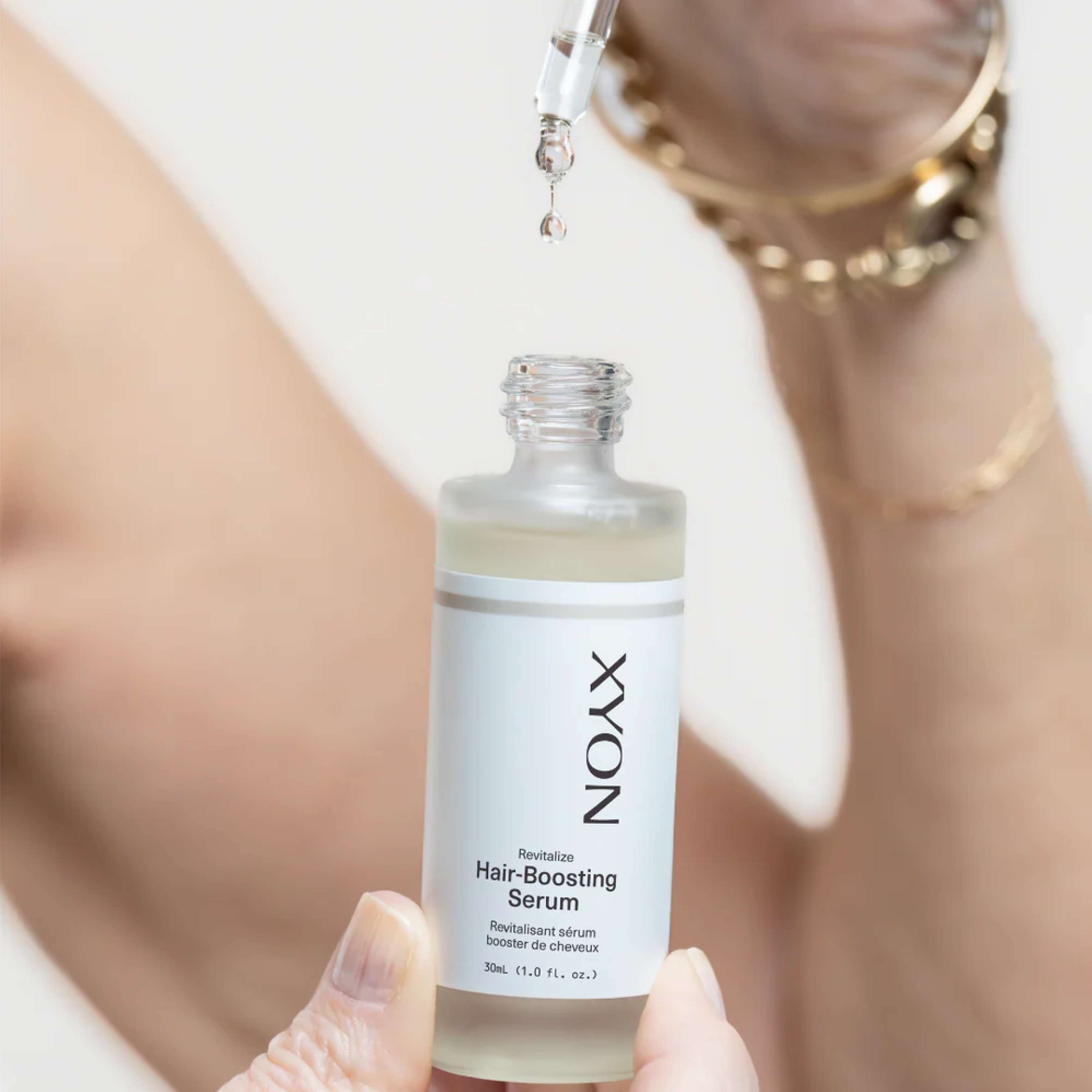 XYON Revitalize Hair-Boosting Serum for women, a hair repair serum showing the product bottle and applicator.
