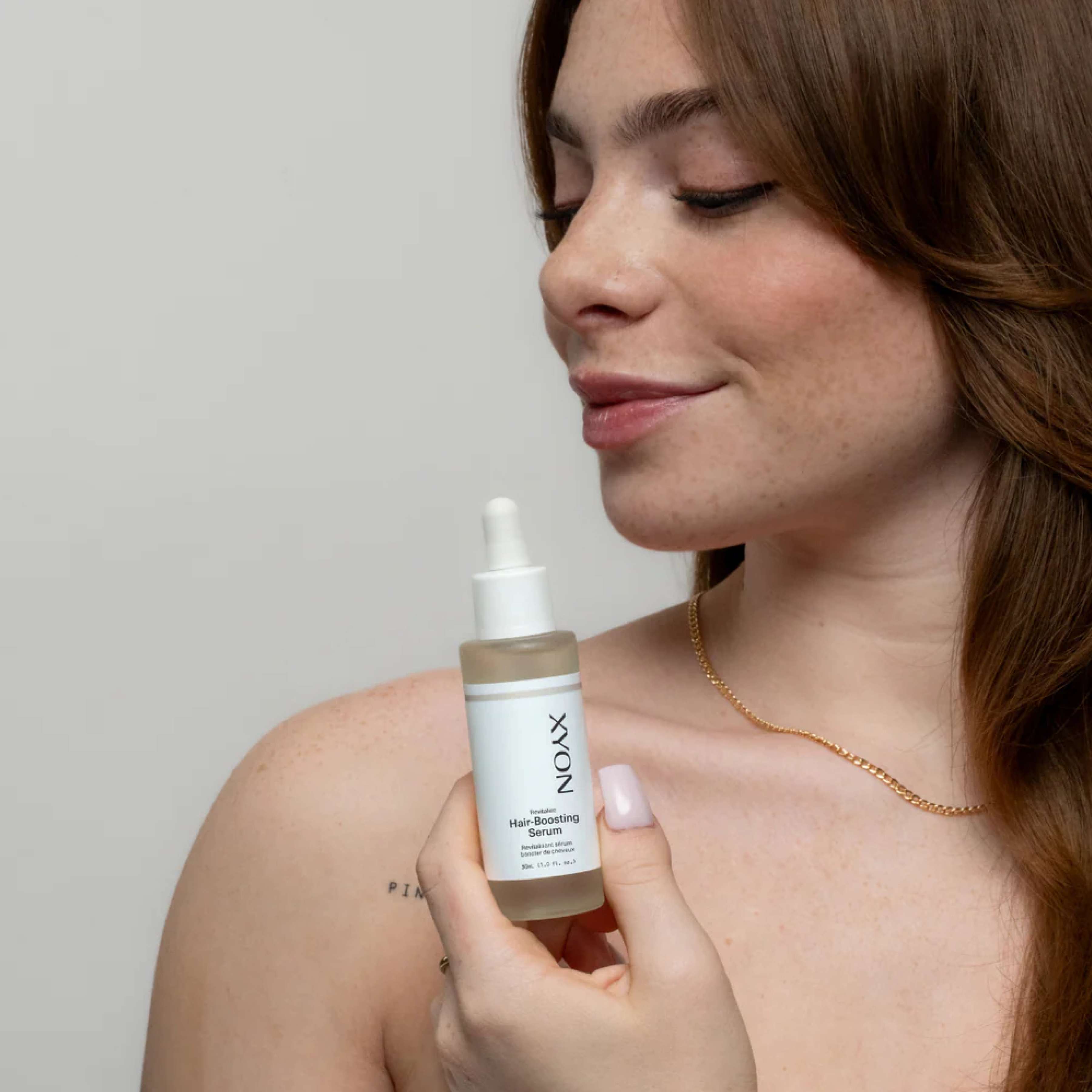 XYON Revitalize hair-boosting serum for women in a sleek bottle, designed to strengthen and rejuvenate hair.