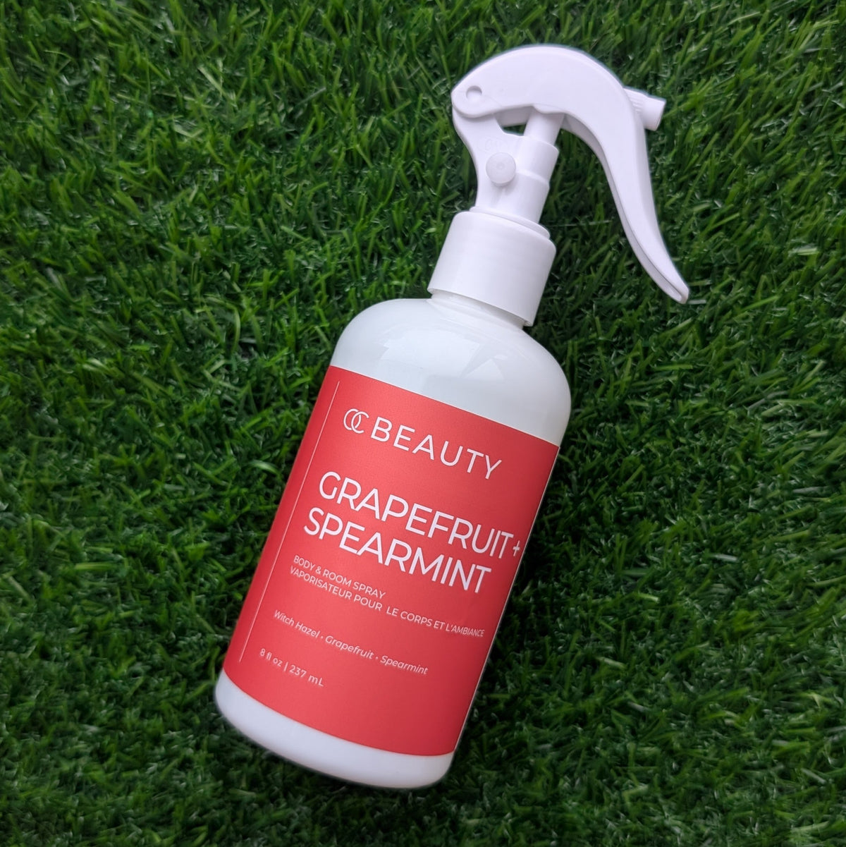 OC Beauty Co. grapefruit and spearmint body and room spray bottle, fresh citrus scent, with a modern design.