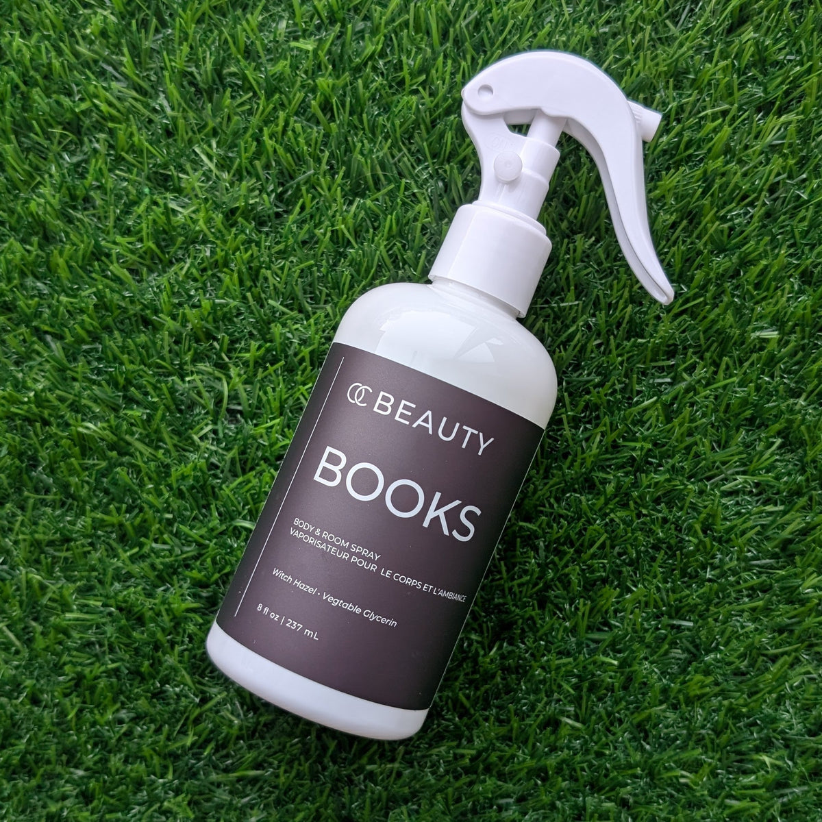 OC Beauty Co. Books Body & Room Spray bottle with linen and body spray label, featuring a sleek design and floral accents.